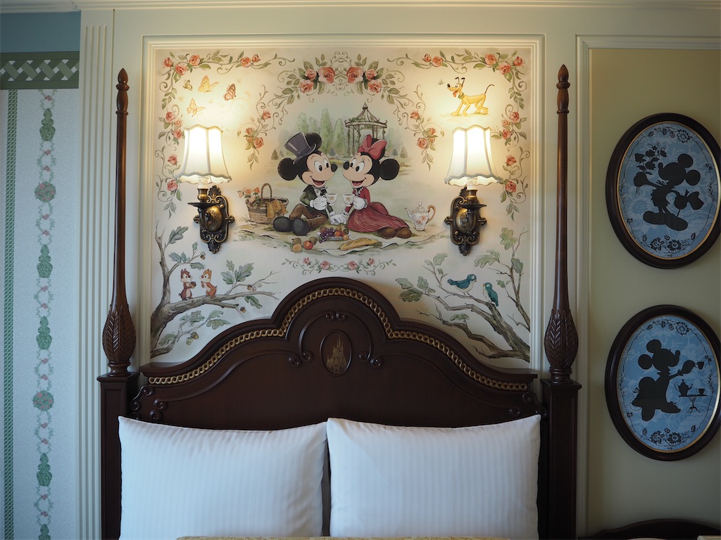 ディズニーランドホテルのベッドの上にはミッキーとミニーがいる。